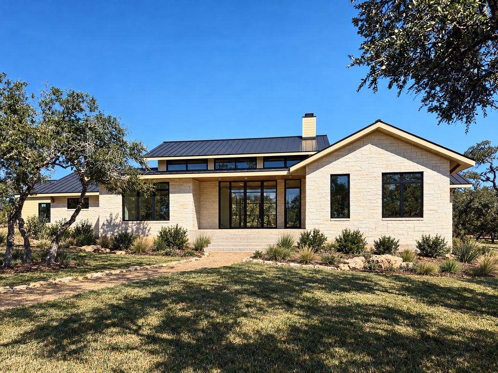 Conceptual rendering of 168 Crooked Creek Court front exterior in Johnson City, TX: single-story limestone home with a standing-seam metal roof and open entry porch among live oaks