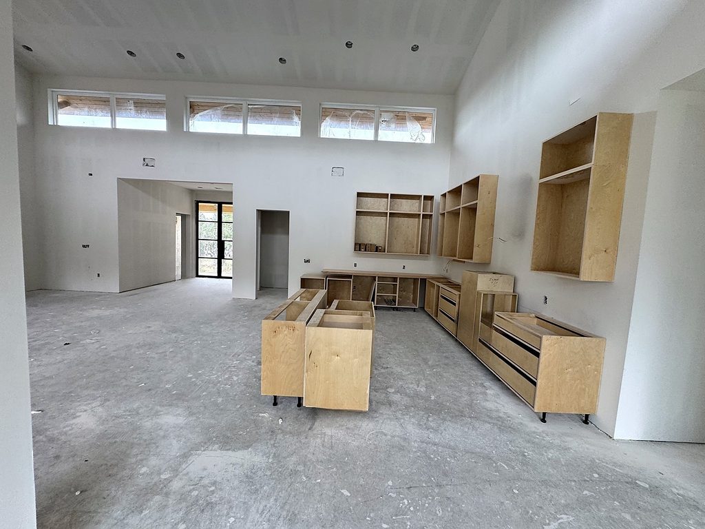 Real photo of kitchen cabinetry and island boxes being installed at 168 Crooked Creek Court, October 2026