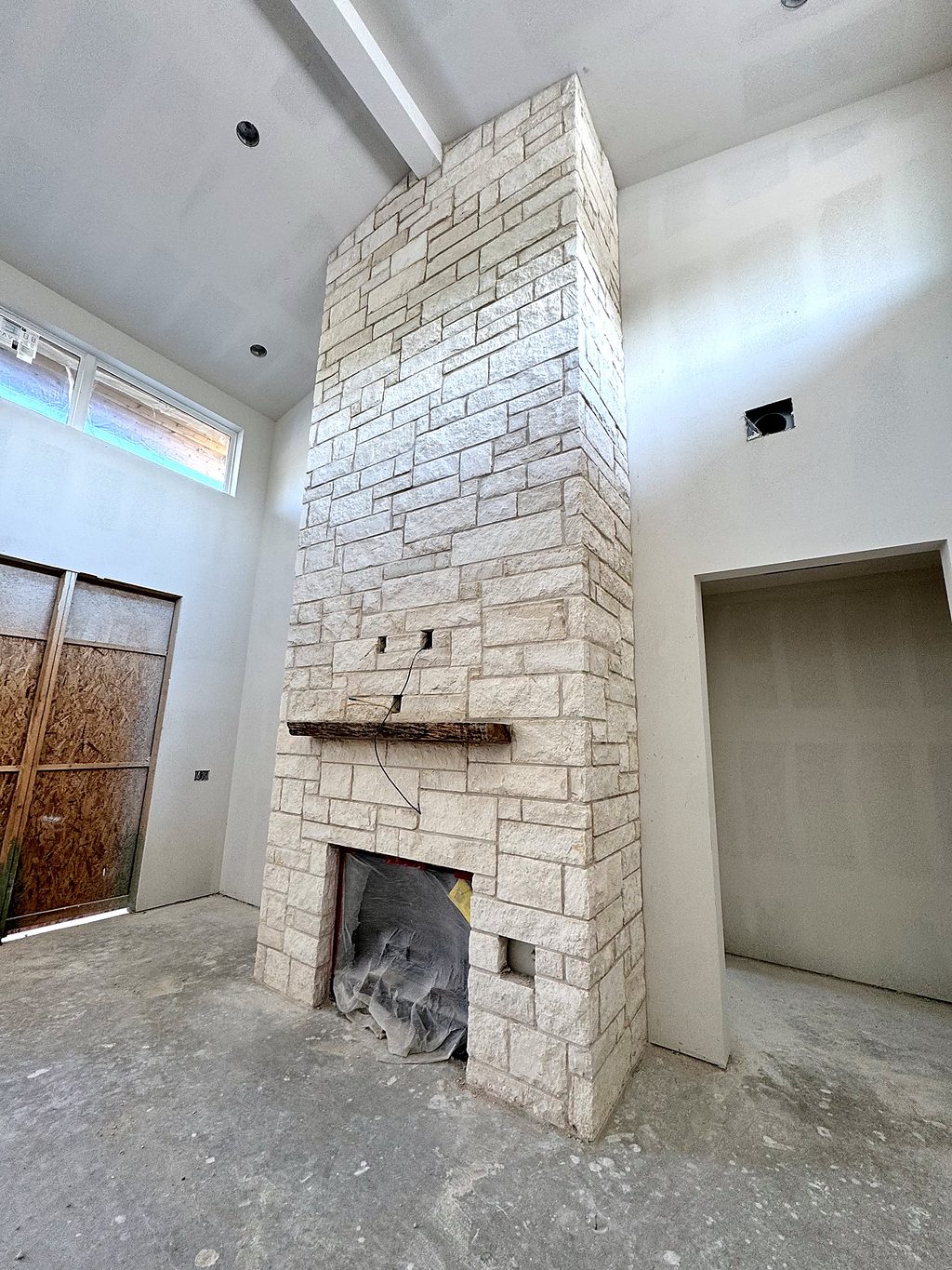 Real photo of the limestone fireplace with rough-hewn wood mantel at 168 Crooked Creek Court, September 2026
