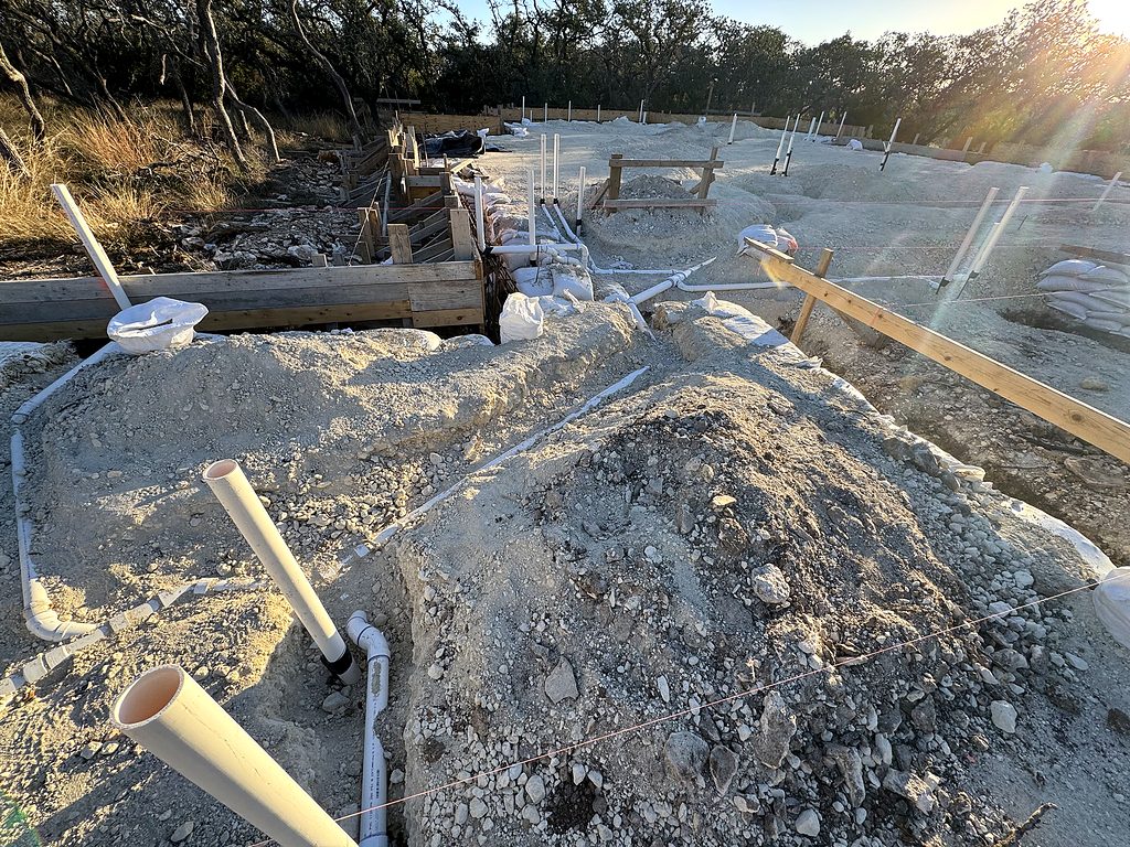 Real photo of foundation forms and under-slab plumbing at 168 Crooked Creek Court, Johnson City, TX, December 2024